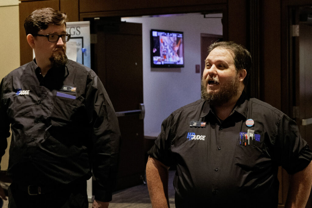 Matt watches John give opening announcements at the Hunter Burton Memorial Open in 2023. Photo © John Brian McCarthy