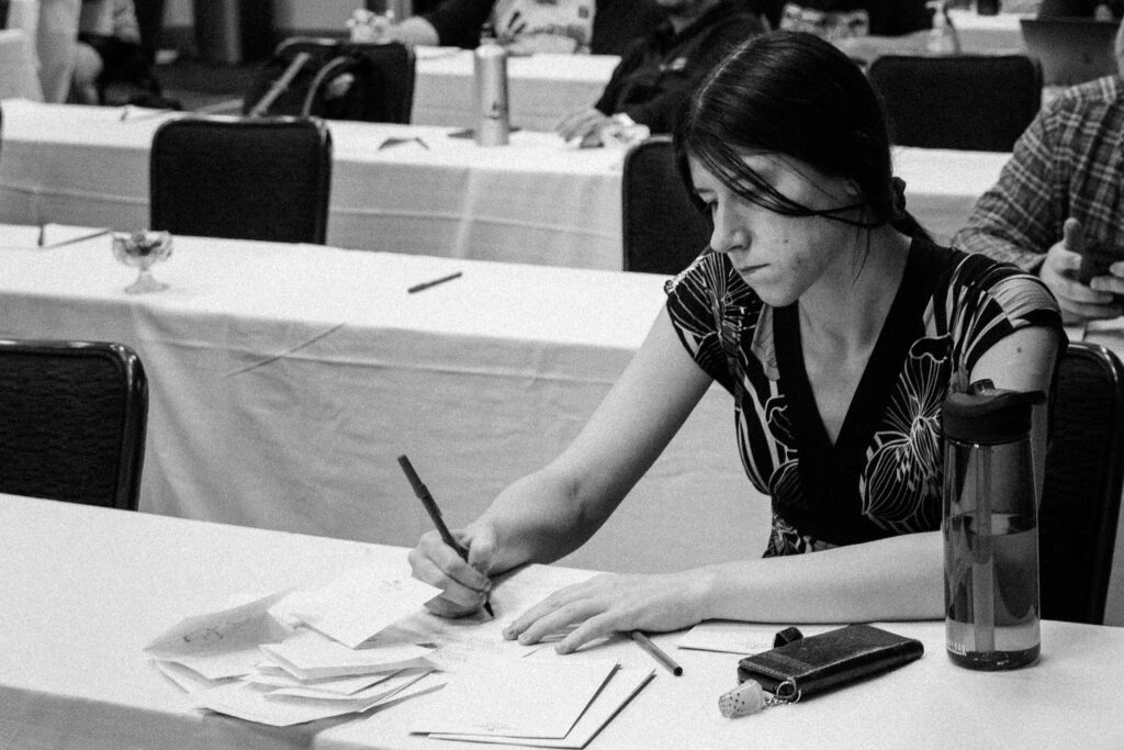 Tobi takes notes during a presentation at the MagicFest Denver Judge Conference in 2019. Photo © John Brian McCarthy
