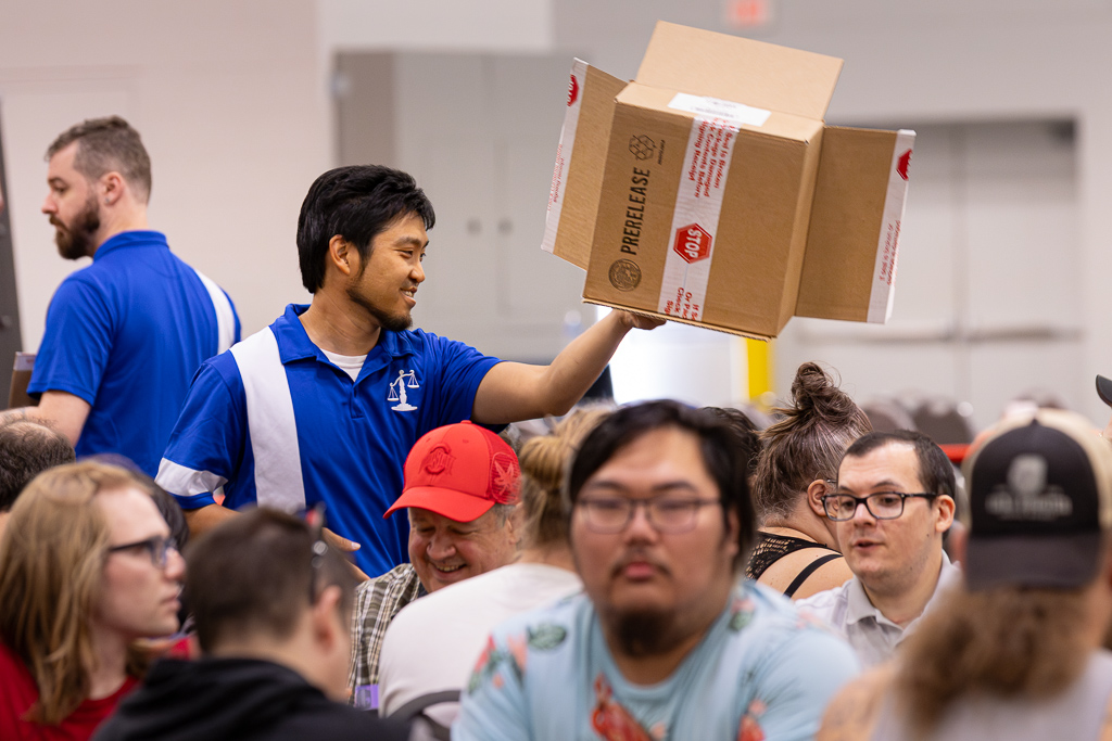 Shane distributes Prerelease kits at SCGCon Columbus in 2023. Photo © John Brian McCarthy