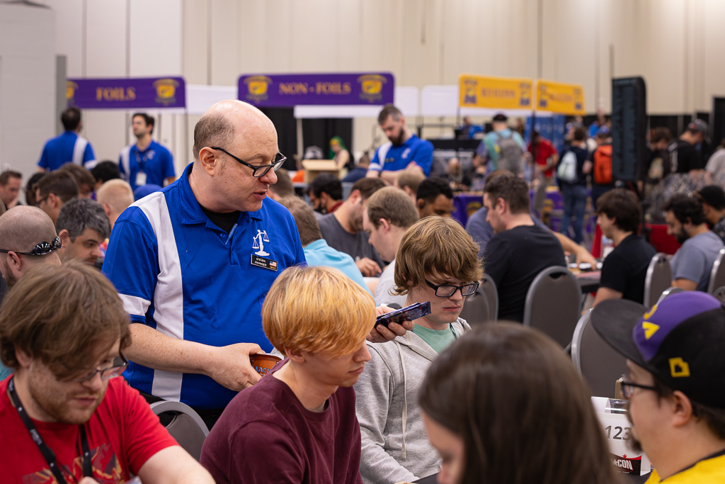 Steven passes out packs for a draft at SCGCon Columbus in 2023. Photo © John Brian McCarthy